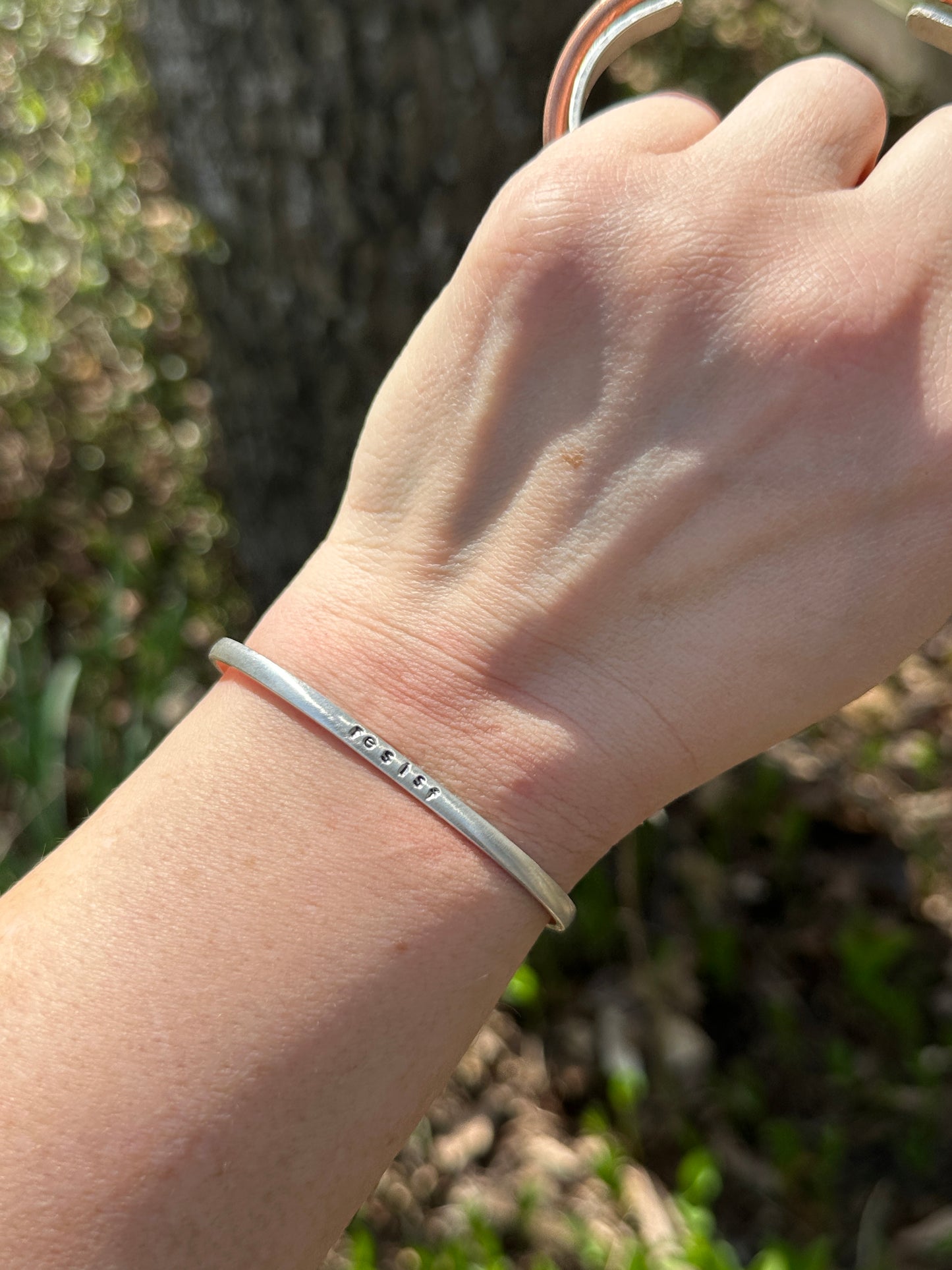 good trouble // resist // hands off cuffs